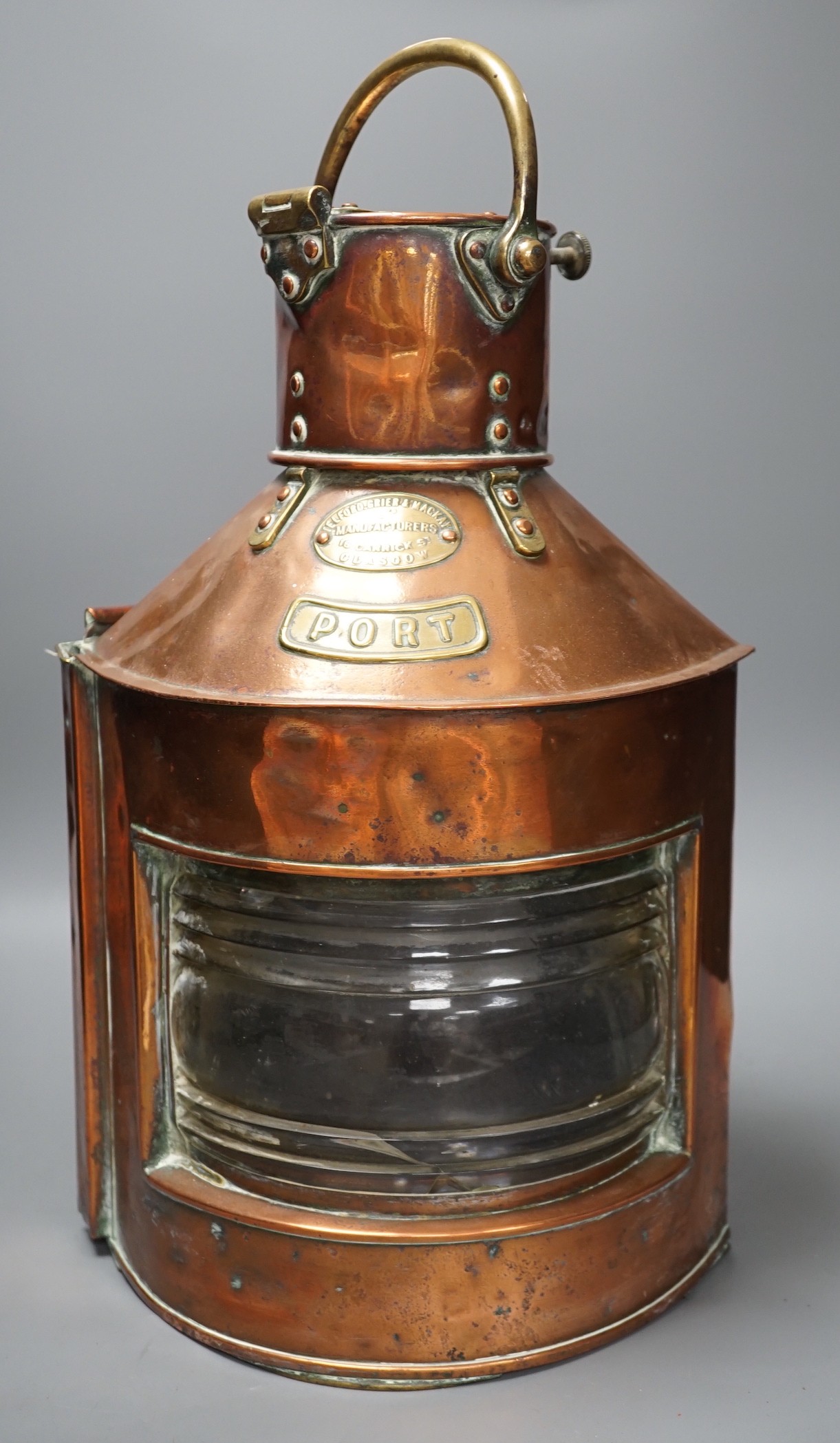 A copper ship’s port lamp, manufactured by Telford.Grier & Mackay, Glasgow, 1918, 42 cms high